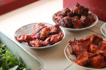 Delicious roasted chicken in white plate.