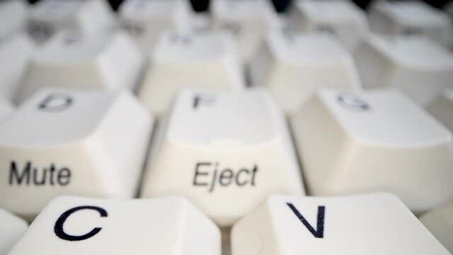White keyboard keys. Camera movement from left to right. Macro photography.