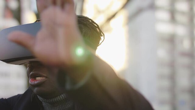 African american black man wearing VR headset in the park. First touch with virtual reality. High quality 4k footage