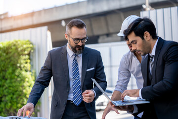 Business people Talk to electrical engineer technician of renewable energy working on an innovative...
