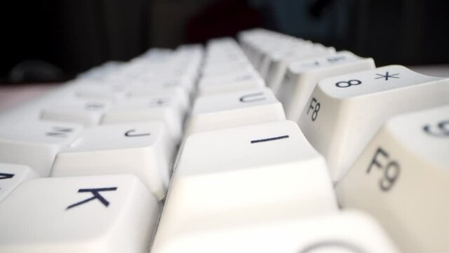 White keyboard keys. Camera movement from left to right. Macro photography.