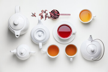 Composition with teapots and cups of tea on white background © Pixel-Shot