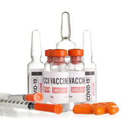 Different vaccines for immunization against COVID-19 and syringes on white background