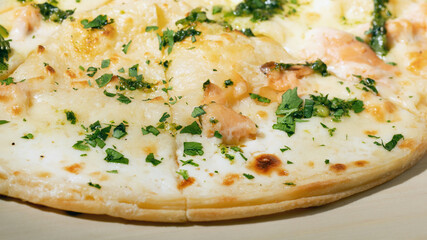 pizza with with salmon, cream cheese and mozzarella cheese on wooden board, close up, macro