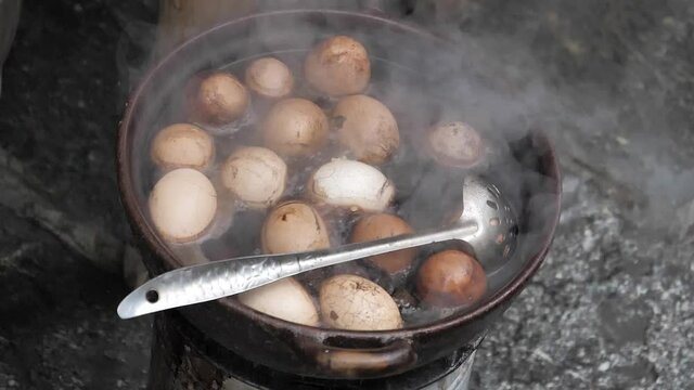 Slow Motion Eggs Boiling in Water Chinese Market in Lijiang, Yunnan, China