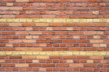 Background from a red brick wall with yellow stripes