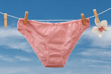 Beautiful women's cotton panties on blue sky background.