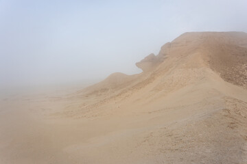 Fototapeta na wymiar The foggy desert landscape