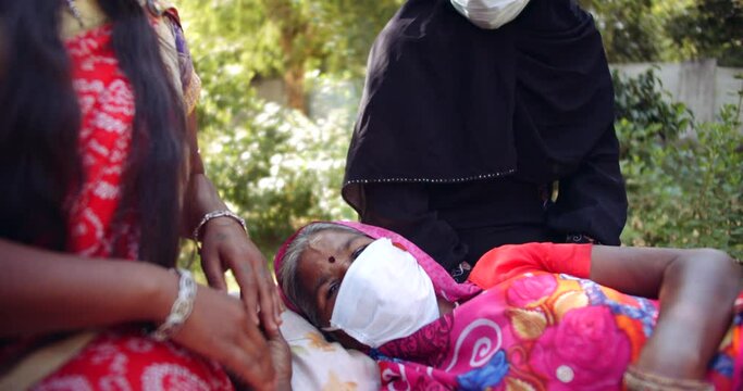 Slow-motion portrait of two females, Hindu and Muslim with face mask outdoors with a patient neighbor family member friend taking care comfort togetherness bonding sharing love empathy humility