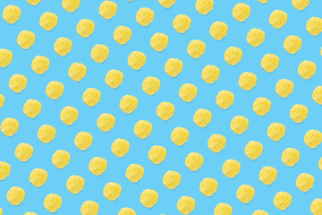 background made from Potato chips on light blue background flat lay. potato snack chips isolated Fast food banner.