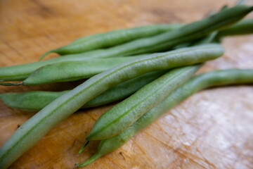 Green beans isolated on a scratched wooden table