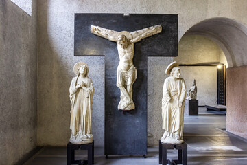 Stone statues of saints and a bas-relief with a crucifix at the exhibition in the Castelvecchio...