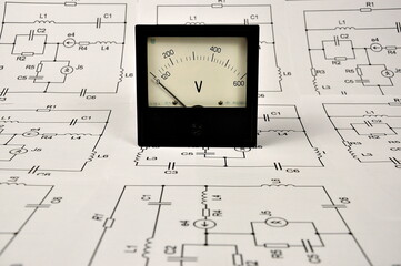Old voltmeter and a paper wiring diagram.