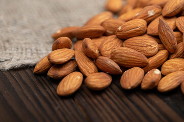 Almonds scattered on the table. Close-up, selective focus.