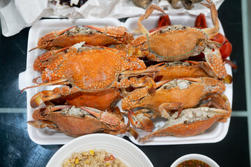 Steamed sea crab in foam box container.