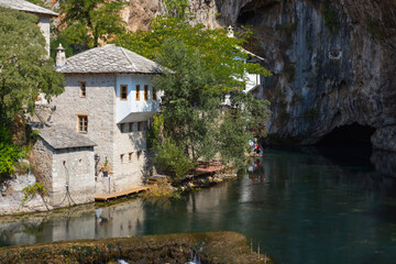 Fototapeta na wymiar Beautiful view of the Dervish House under the rock in Blagaj. Bosnia and Herzegovina