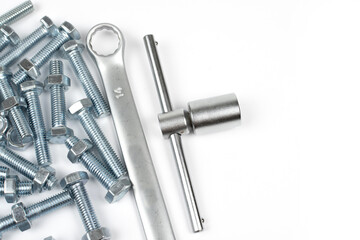 light metal bolts and tool on white background