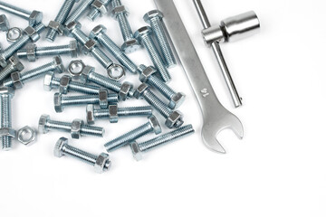 light metal bolts and tool on white background