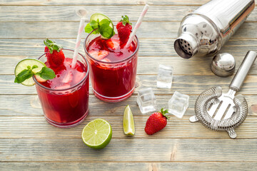 Red drink coktail with strawberry, ice and mint. Cocktail making bar tools