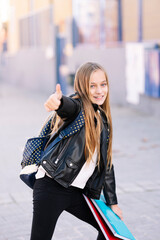 Fototapeta premium Student girl on the way to school making positive gestures