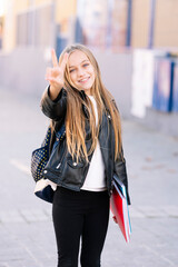 Fototapeta premium Student girl on the way to school making positive gestures