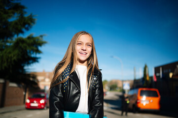 Fototapeta premium Little student girl on the way to school