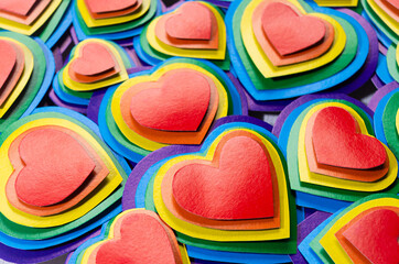 Festive lgbt Valentines day background - multicolored valentines hearts, pattern, top view.