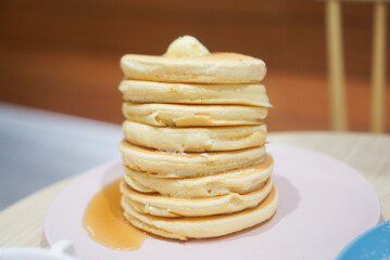Original fluffy pancake stacks with butter and maple syrup. Center.