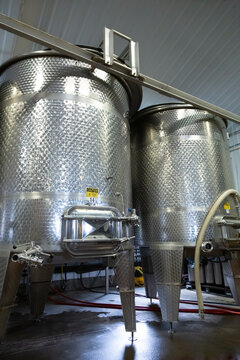 Two Large Stainless Steel Commercial Wine Holding Fermentation Blending Tanks, Cement Ground, Indoors - Oregon
