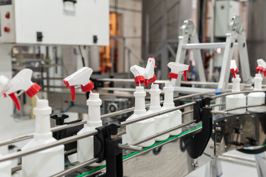 Plastic Bottles, Sprayers, On The Automated Conveyor Line On The Chemical Factory. Cleaners Production. Shallow Depth Of Field.