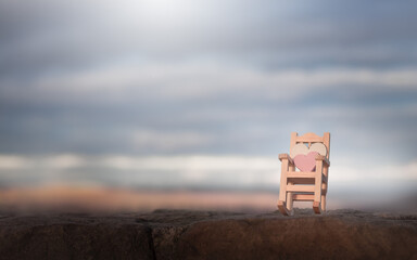 Happy Valentines day.Enjoy the sunset.Two hearts on the armchair.