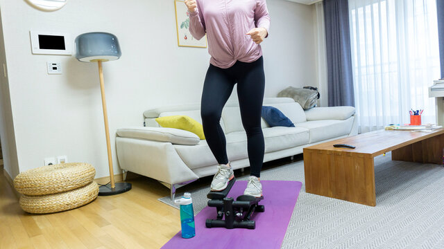 cardio exercising at home on stepper trainer during the covid-19.
