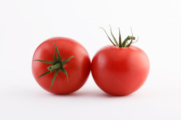 Two red tomatoes with tails