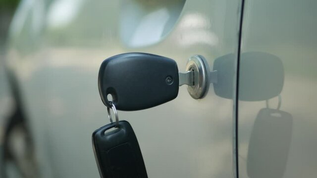 Close-Up Image with Keys and Remote Control in the Car Door Lock