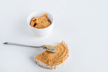 Rice cakes with Homemade Creamy peanut butter or paste white background. Delicious breakfast or snack concept. Close up
