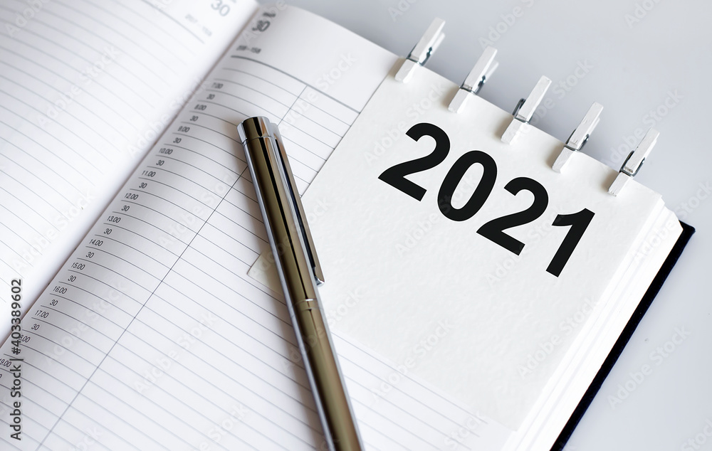 Poster text 2021 on the short note texture background with pen