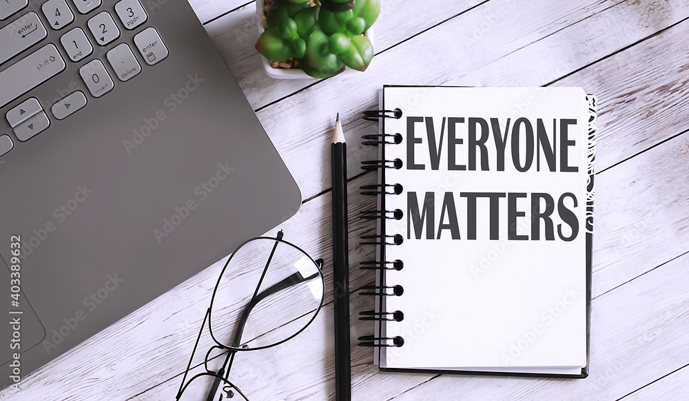 Poster everyone matters text on notebook with office background