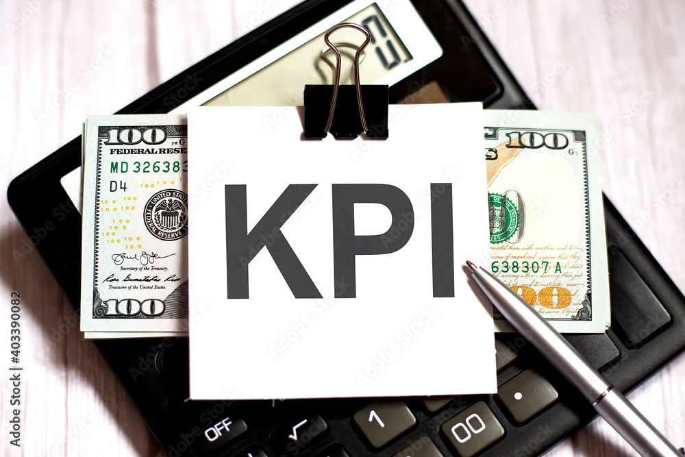 Poster white paper with text kpi with dollars on calculator with pen