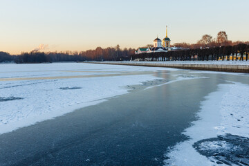 Count Sheremetev's Palace in Kuskovo park in winter at sunset. Сhurch of the Savior, bell tower...