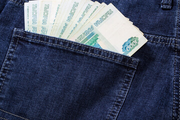 
Russian money is in jeans pocket in denominations of 1000 rubles.