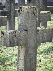 Solid stone cross in a cemetery. Close up detail.