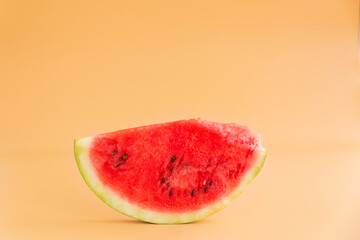 Slice of watermelon isolated on orange background.
