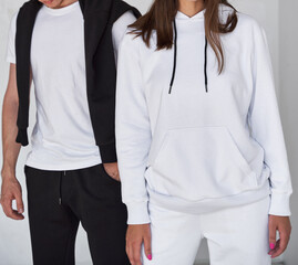 man and woman standing in white hoodies. mock up for clothing branding.