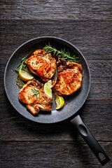 fried pork chops on a skillet, top view