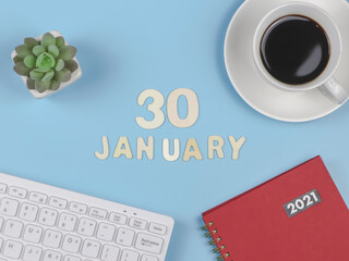  flat lay of wooden letters 30 JANUARY on blue background with red 2021 diary, computer keyboard, cup of black coffee and succulent plant pot.