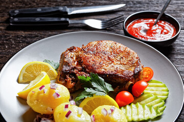 pork cutlets with boiled potato and cucumber