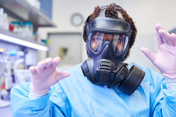 African researcher with full face mask in the laboratory