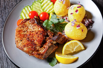 pork cutlets with boiled potato and cucumber