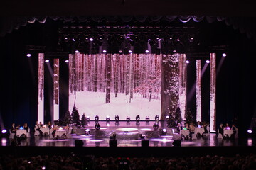 An empty stage of the scene concert hall, lit by spotlights and smoke 