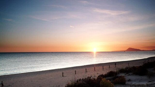 Time lapse of sunrise over sea. View from Gandia beach, Valencia Spain.